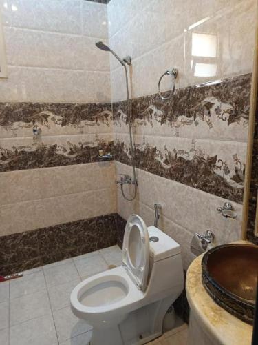 a bathroom with a toilet and a shower at Quiet Rooms 2 Serviced Apartments in Riyadh