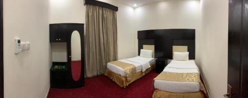 a room with two beds in a hotel room at Quiet Rooms 2 Serviced Apartments in Riyadh