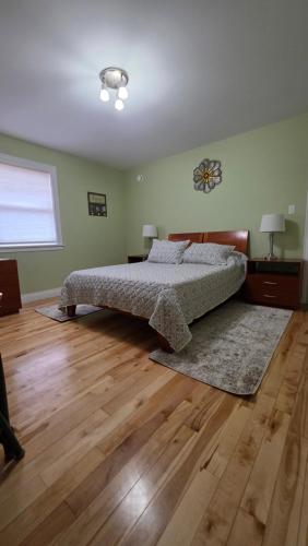 a bedroom with a bed and a wooden floor at Small Town Bound Inn in Vernon River