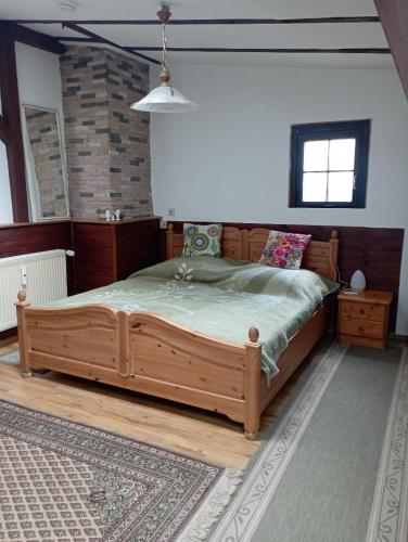 a bedroom with a large wooden bed in a room at Ferienwohnung Vogelnest in Templin