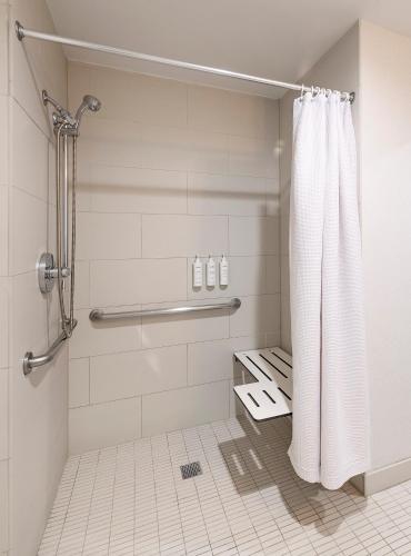 a bathroom with a shower with a shower curtain at The Wayfarer San Diego in San Diego