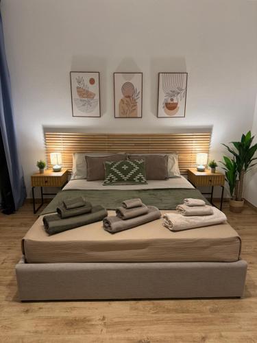 a bedroom with a large bed with two night stands at Maison Piave 35 in Olbia
