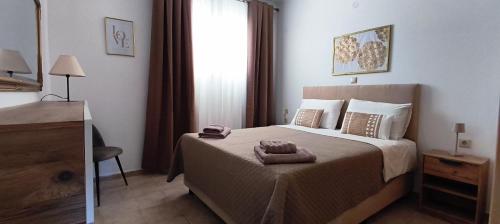 a bedroom with a bed with two towels on it at Golden rose in Corfu