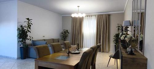 a dining room and living room with a table and chairs at Golden rose in Corfu