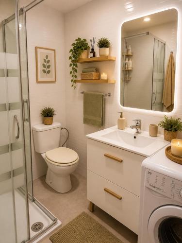 a bathroom with a toilet and a sink and a shower at APARTAMENTOS VIALIA SOL y PLAYA in Málaga