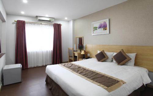 a hotel room with a large bed and a window at Blue Pearl Hanoi Hotel in Hanoi