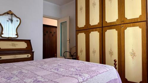 a bedroom with a bed and a dresser at A Due Onde, Viola Mare in Alassio