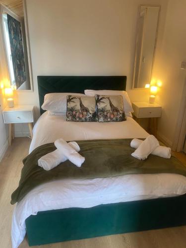 a bedroom with a bed with two towels on it at Sky View Cabin in Ardaghy