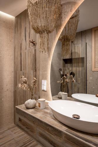 a bathroom with a large tub and a sink at Villa La Roca Garden & Spa ADULTS ONLY in Kościelisko