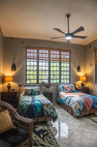 a bedroom with two beds and a ceiling fan at Vieques BioBay Bed and Breakfast in Vieques