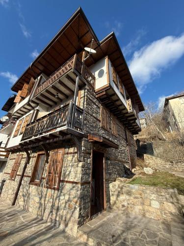an old stone building with a balcony on it at Родопски Рай in Slaveino