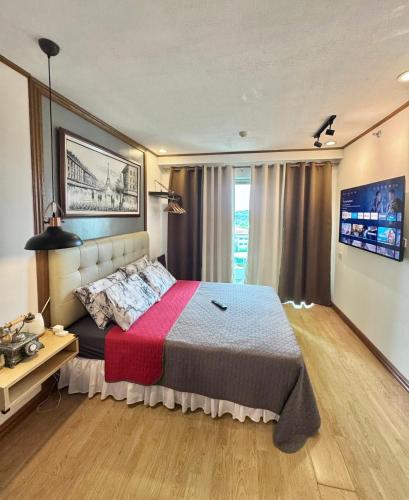 a bedroom with a large bed with a red blanket at A Comfy Place in Tagaytay in Sampong