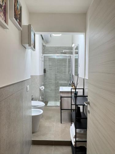 a bathroom with a toilet and a sink and a shower at B&B International in Saviano