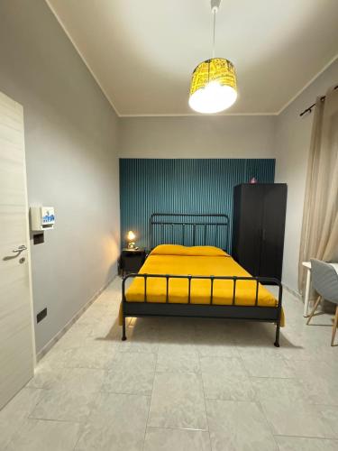 a bedroom with a yellow bed in a room at B&B International in Saviano