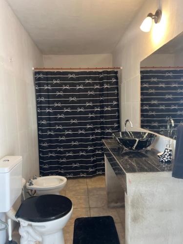 a bathroom with a toilet and a sink at La Esperanza in Deán Funes