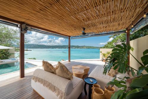 a living room with a couch and a view of the ocean at Private Oceanfront Villa Kingfisher - 20m Infinity Pool in Nusa Lembongan