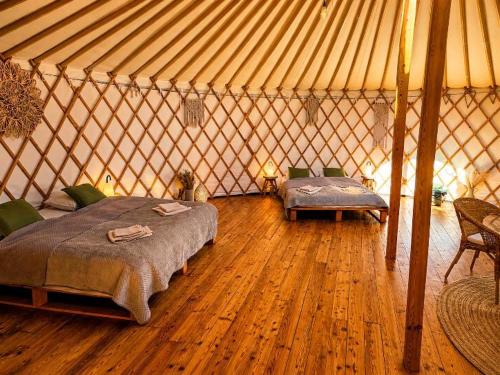 a bedroom with two beds in a yurt at Jurty u jezírka in Mostek