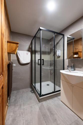 a bathroom with a shower and a sink at Le Bois-Gentil in Gryon