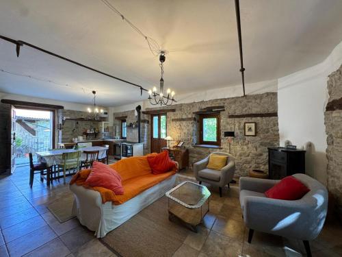 a living room with a couch and a table at Villa delle Fonti - Villa With Pool in Toano