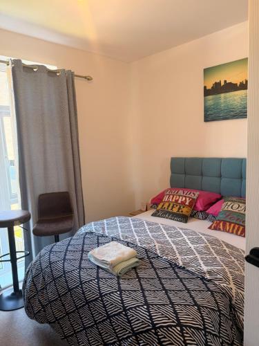 a bedroom with a bed and a chair and a window at Foundry place Rotherham, Sheffield in Rotherham