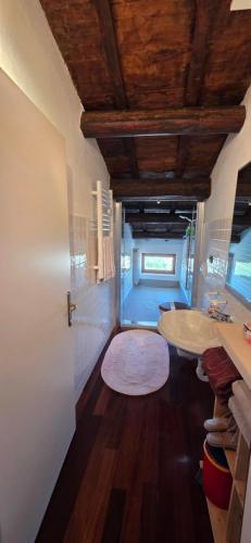 a bathroom with a tub and a sink in a room at Skyline Virgilio SUITE sottotetto vista MARE parking in San Marino