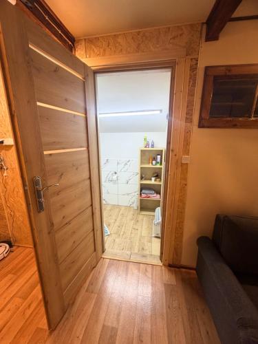 a door leading into a room with a couch at Letnisko na Pierkunowie in Giżycko