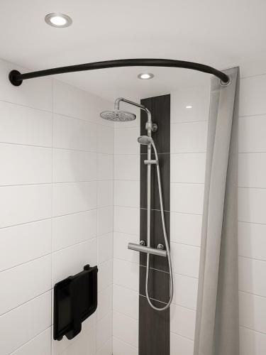 a shower with a glass door in a bathroom at Gîte des 3 Suissesses in Saint-Paul