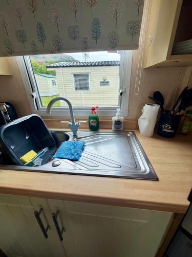 a sink in a kitchen with a window at The Conwy Escape in Conwy