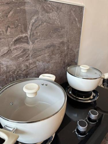 a kitchen with a pot and a bowl on a stove at Arceo Homestay 2 Bedroom unit in Puerto Princesa City