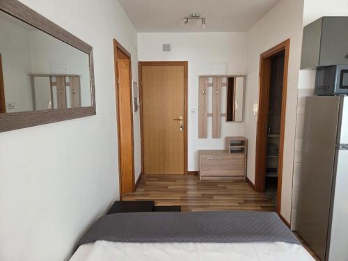 a bedroom with a bed and a mirror on the wall at House Bogović in Karlovac