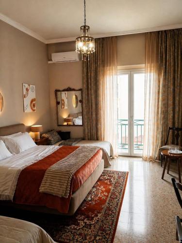 a hotel room with a bed and a large window at Sagittarius B&B in Cetraro