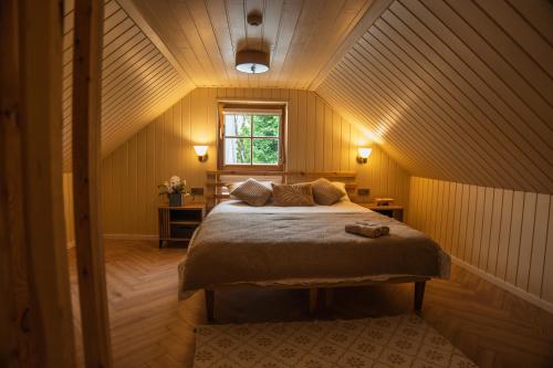 a bedroom with a bed in a small room at Prance namai in Plateliai