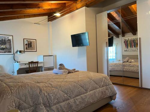 a bedroom with a bed and a desk and a television at Dolce Vita in Altivole