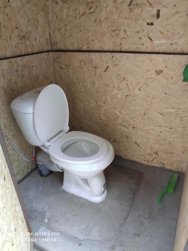 a bathroom with a toilet in a wall at Guesthouse Shakirbek in Arslanbob