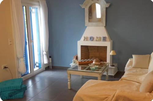a living room with a couch and a fireplace at Terra Naxos in Galini