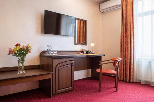 a hotel room with a desk and a chair at Edem Hotel Lviv in Lviv