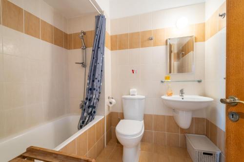 a bathroom with a toilet and a sink and a tub at Peyia Hilltop Retreat - Village Views & Sunsets in Peyia