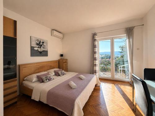 a bedroom with a bed and a large window at New! Apartment Complex "S" in Čelina