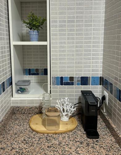 a bathroom sink with a soap dispenser on a counter at Apartamento Mar Blava Chilches in Chilches