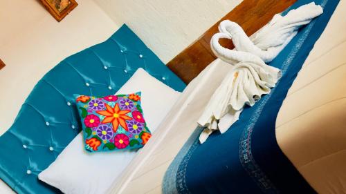 a bed with a blue umbrella and a pillow at Hostal sambleño cusco Piero suite in Cusco