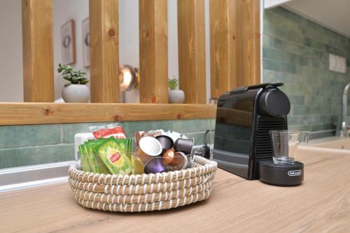 a basket of food sitting on a counter next to a toaster at Lito2Apart in Litochoro