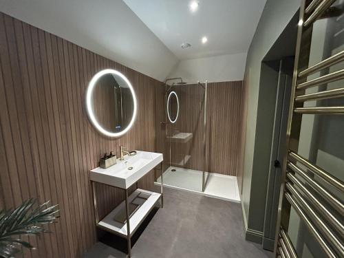 a bathroom with a sink and a shower at Broombarns Farm Cottage in Forgandenny