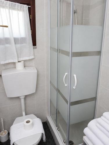a bathroom with a toilet and a glass shower at Villino Isò in La Spezia