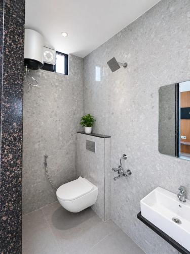 a bathroom with a toilet and a sink at Lado by Stay Junction in Indore