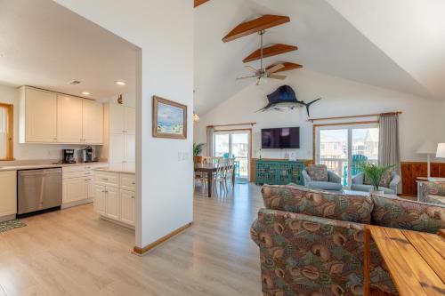 an open kitchen and living room with a couch at Seagrove View - NH MP 10.5, Oceanside, 800 ft to the BEACH, YMCA Passes in Nags Head