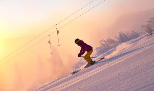 a man is skiing down a snow covered slope at Rehwinkel in Bodenmais