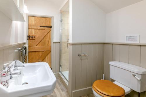 a bathroom with a sink and a toilet at 4 Bed in Looe oc-p00795 in Lansallos