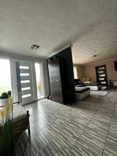 a large living room with a couch and a table at BÉTA Apartman in Sárospatak