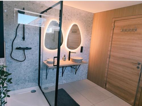 a bathroom with a shower with a sink and a mirror at LA SUITE 159 in Namur
