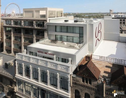an aerial view of a building with a ferris wheel in the background at Bresoles Hotel in Montreal